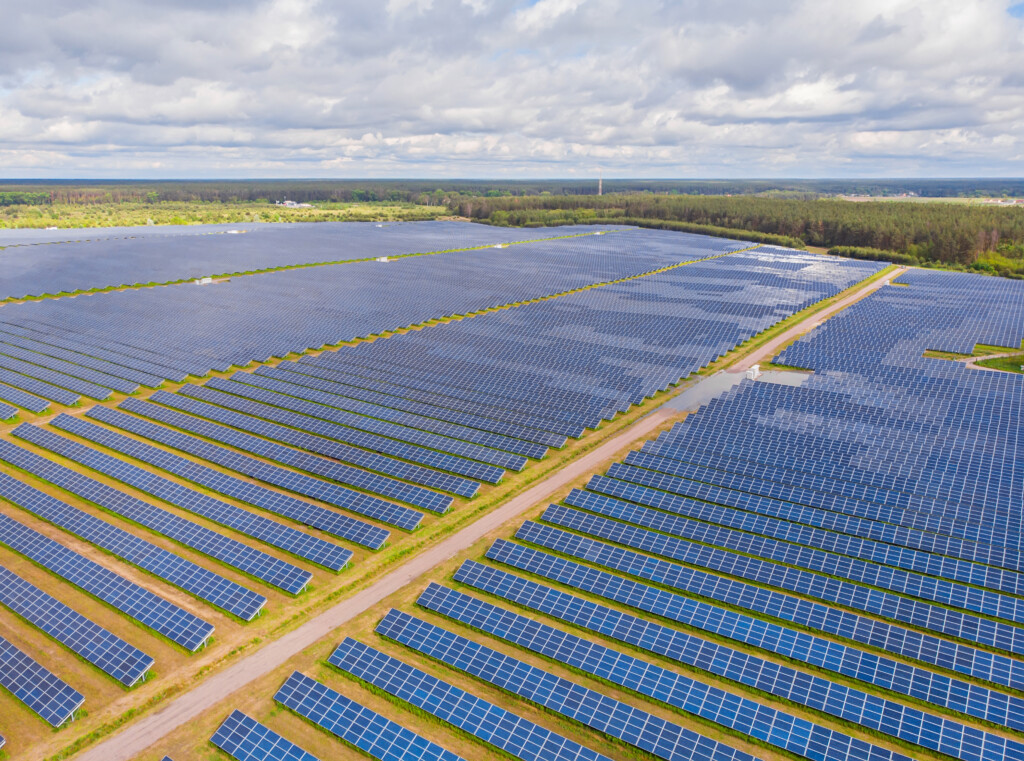 Solar panel produces green, environmentaly friendly energy from the setting sun. Aerial view from drone. Landscape picture of a solar plant that is located inside a valley