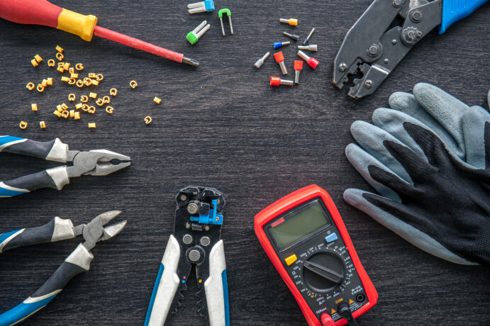 Different electrical tools on wooden background