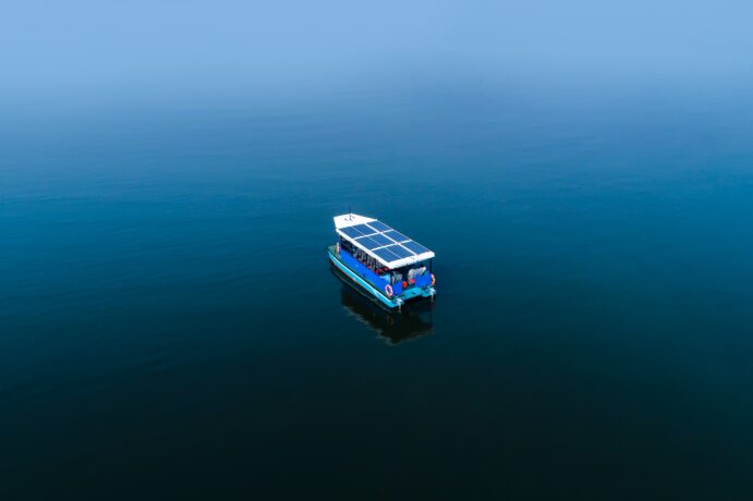 A boat with solar roof in the middle of the sea