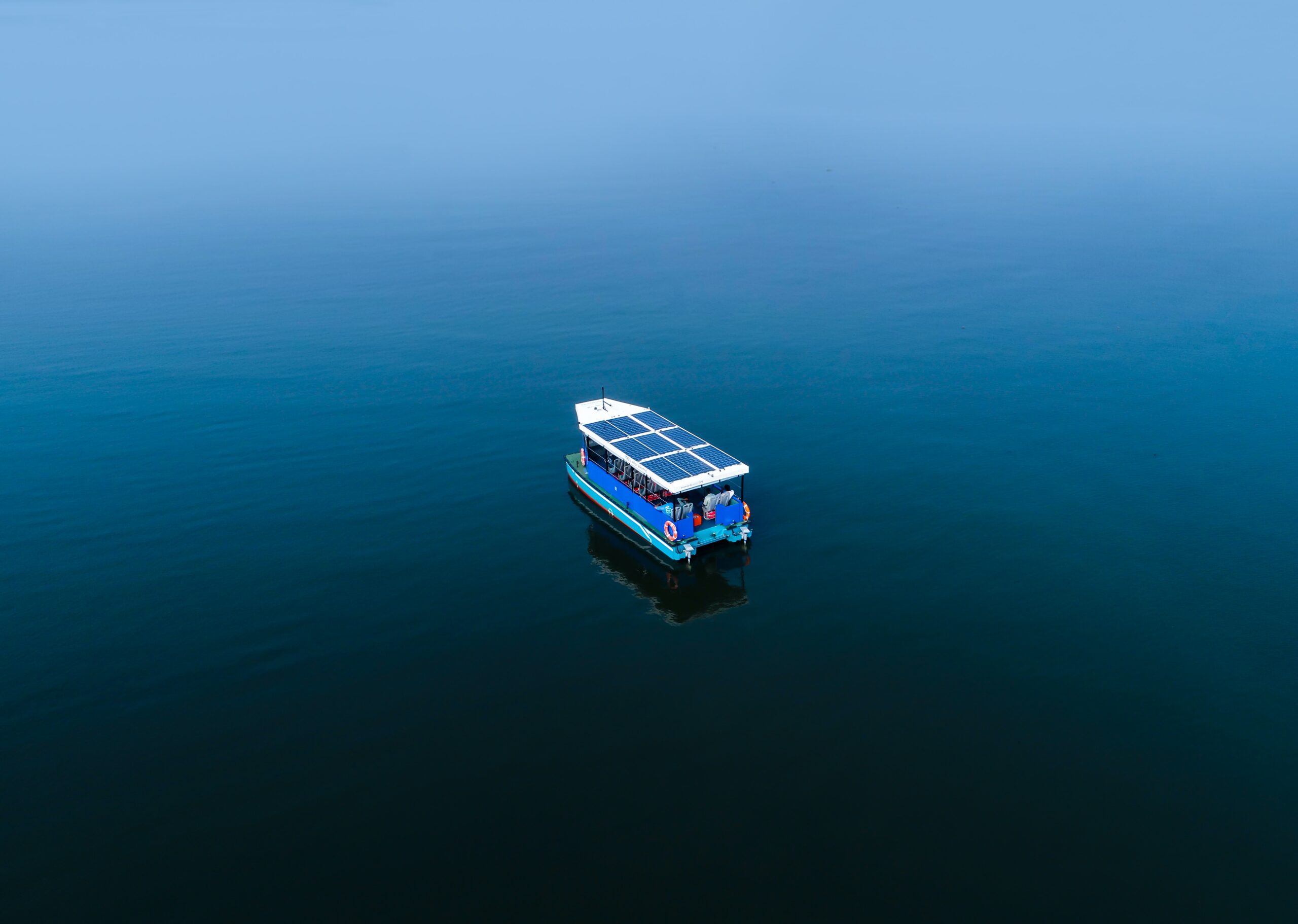 A boat with solar roof in the middle of the sea